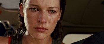 Movie still from “A Perfect Getaway” (2009), directed by David Twohy – A woman's face with green eyes; Close Up shot, Low angle