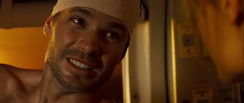 Movie still from “A Perfect Getaway” (2009), directed by David Twohy – A person wearing a hat; Close Up shot, Over the shoulder angle