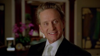 Movie still from “A Perfect Murder” (1998), directed by Andrew Davis – An older man in a suit smiling for the camera; Close Up shot, Low angle