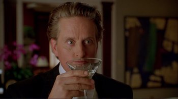 Movie still from “A Perfect Murder” (1998), directed by Andrew Davis – A man in a suit and tie holding a glass of wine; Close Up shot, Over the shoulder angle