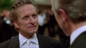 Movie still from “A Perfect Murder” (1998), directed by Andrew Davis – A person wearing a suit and tie; Close Up shot, Over the shoulder angle