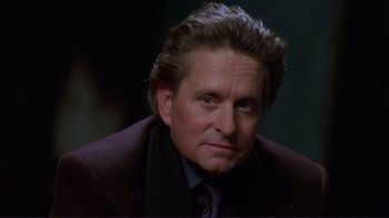 Movie still from “A Perfect Murder” (1998), directed by Andrew Davis – A person wearing a suit and tie; Close Up shot, Over the shoulder angle