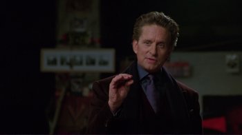 Movie still from “A Perfect Murder” (1998), directed by Andrew Davis – A person wearing a suit and tie; Close Up shot, Over the shoulder angle