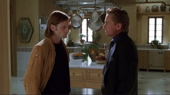 Movie still from “A Perfect Murder” (1998), directed by Andrew Davis – Two people in a kitchen talking to each other; Medium shot, Over the shoulder angle