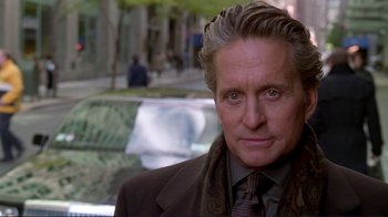 Movie still from “A Perfect Murder” (1998), directed by Andrew Davis – A person wearing a suit and tie; Close Up shot, Over the shoulder angle