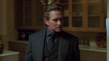 Movie still from “A Perfect Murder” (1998), directed by Andrew Davis – A person wearing a suit and tie; Close Up shot, Over the shoulder angle
