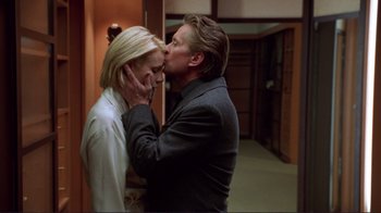 Movie still from “A Perfect Murder” (1998), directed by Andrew Davis – A man and a woman kissing each other in a room; Close Up shot, Low angle