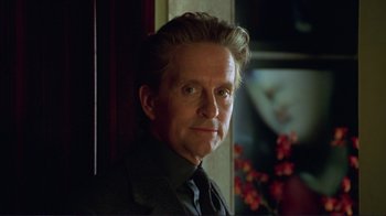 Movie still from “A Perfect Murder” (1998), directed by Andrew Davis – A person wearing a suit and tie; Close Up shot, Over the shoulder angle