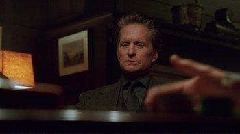 Movie still from “A Perfect Murder” (1998), directed by Andrew Davis – A person sitting at a table; Close Up shot, Low angle