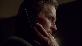 Movie still from “A Perfect Murder” (1998), directed by Andrew Davis – An older man talking on a cell phone; Close Up shot, Low angle