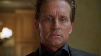 Movie still from “A Perfect Murder” (1998), directed by Andrew Davis – A person wearing a suit and tie; Close Up shot, Low angle