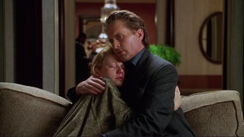 Movie still from “A Perfect Murder” (1998), directed by Andrew Davis – A man and a woman wrapped in a blanket; Medium shot, Low angle