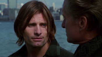 Movie still from “A Perfect Murder” (1998), directed by Andrew Davis – A man with long hair is looking at another man; Close Up shot, Over the shoulder angle