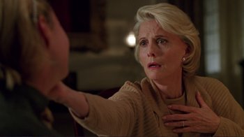 Movie still from “A Perfect Murder” (1998), directed by Andrew Davis – An older woman holding her hand up to her face; Close Up shot, Over the shoulder angle