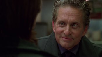 Movie still from “A Perfect Murder” (1998), directed by Andrew Davis – An older man wearing a suit and a tie; Close Up shot, Over the shoulder angle