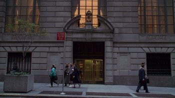 Movie still from “A Perfect Murder” (1998), directed by Andrew Davis – A group of people walking down a sidewalk near a building; Extreme Wide shot, Low angle