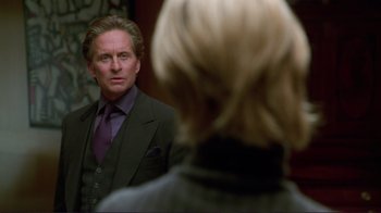 Movie still from “A Perfect Murder” (1998), directed by Andrew Davis – A man standing in front of a woman looking at him in the mirror; Medium shot, Over the shoulder angle