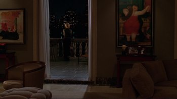 Movie still from “A Perfect Murder” (1998), directed by Andrew Davis – A woman standing on a balcony at night looking out a window; Wide shot, High angle