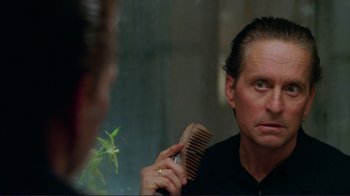Movie still from “A Perfect Murder” (1998), directed by Andrew Davis – A man combing his hair in front of a mirror; Close Up shot, Over the shoulder angle