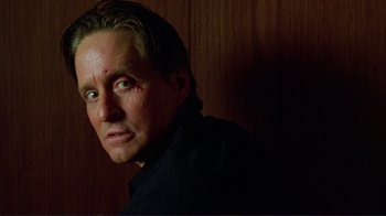 Movie still from “A Perfect Murder” (1998), directed by Andrew Davis – A person wearing a black shirt; Close Up shot, Low angle