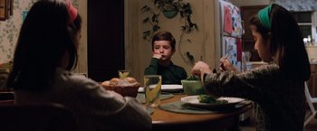 Movie still from “A Perfect World” (1993), directed by Clint Eastwood – A young boy sitting at a table with a plate of food; Medium shot, High angle