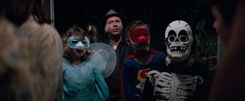 Movie still from “A Perfect World” (1993), directed by Clint Eastwood – A group of people dressed up in costumes; Medium shot, Low angle