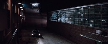 Movie still from “A Perfect World” (1993), directed by Clint Eastwood – A car driving down a street at night; Extreme Wide shot, High angle