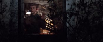 Movie still from “A Perfect World” (1993), directed by Clint Eastwood – A young boy standing in front of a train window; Medium shot, Low angle