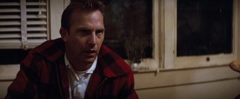Movie still from “A Perfect World” (1993), directed by Clint Eastwood – A man wearing a red and black jacket looking to his left; Close Up shot, Low angle