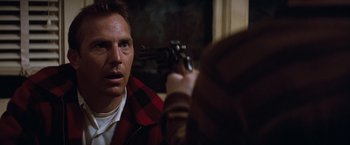 Movie still from “A Perfect World” (1993), directed by Clint Eastwood – A man holding a gun in front of a mirror; Close Up shot, Over the shoulder angle