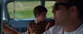 Movie still from “A Perfect World” (1993), directed by Clint Eastwood – A man and a boy sitting in a vehicle; Close Up shot, Over the shoulder angle