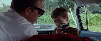Movie still from “A Perfect World” (1993), directed by Clint Eastwood – A man and a boy in the back seat of a car; Close Up shot, Over the shoulder angle