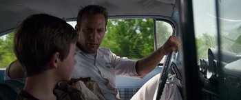 Movie still from “A Perfect World” (1993), directed by Clint Eastwood – A man and a boy in a car driving; Close Up shot, Over the shoulder angle