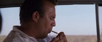 Movie still from “A Perfect World” (1993), directed by Clint Eastwood – A person lighting a cigarette; Close Up shot, Low angle