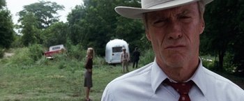 Movie still from “A Perfect World” (1993), directed by Clint Eastwood – A man wearing a white hat standing in front of an airstream trailer; Close Up shot, Low angle