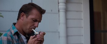 Movie still from “A Perfect World” (1993), directed by Clint Eastwood – A person lighting a cigarette; Close Up shot, Low angle