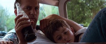 Movie still from “A Perfect World” (1993), directed by Clint Eastwood – A man and a child in a car; Close Up shot, Low angle