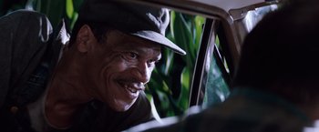 Movie still from “A Perfect World” (1993), directed by Clint Eastwood – A man in a hat looking out of a car window; Close Up shot, Over the shoulder angle