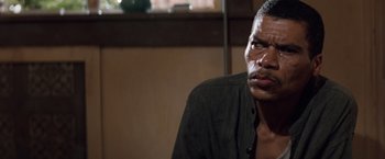 Movie still from “A Perfect World” (1993), directed by Clint Eastwood – A person sitting in a room; Close Up shot, Over the shoulder angle