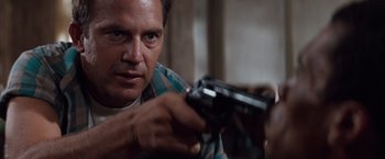 Movie still from “A Perfect World” (1993), directed by Clint Eastwood – A person holding a gun; Close Up shot, Low angle