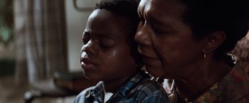 Movie still from “A Perfect World” (1993), directed by Clint Eastwood – An older woman and a young boy are looking at each other; Close Up shot, Low angle