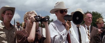 Movie still from “A Perfect World” (1993), directed by Clint Eastwood – A man in a white hat is looking through binoculars; Medium shot, Low angle