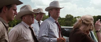 Movie still from “A Perfect World” (1993), directed by Clint Eastwood – A group of men in hats and ties standing next to each other; Medium shot, Low angle