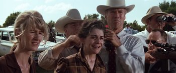 Movie still from “A Perfect World” (1993), directed by Clint Eastwood – A woman being shaved by two men in cowboy hats; Medium shot, Over the shoulder angle