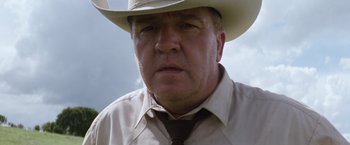 Movie still from “A Perfect World” (1993), directed by Clint Eastwood – A person wearing a cowboy hat; Close Up shot, Low angle