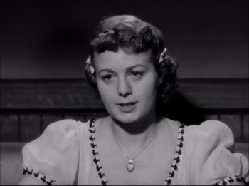 Movie still from “A Place in the Sun” (1951), directed by George Stevens – An old black and white photo of a woman; Close Up shot, Low angle