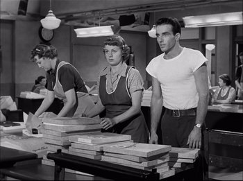 Movie still from “A Place in the Sun” (1951), directed by George Stevens – A group of people standing around a table; Medium shot, Low angle