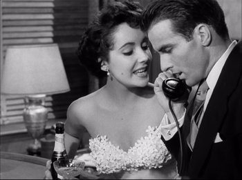 Movie still from “A Place in the Sun” (1951), directed by George Stevens – A man and a woman talking on a phone; Close Up shot, Low angle