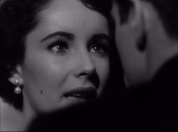 Movie still from “A Place in the Sun” (1951), directed by George Stevens – A black - and - white photo of a woman's face; Close Up shot, Over the shoulder angle
