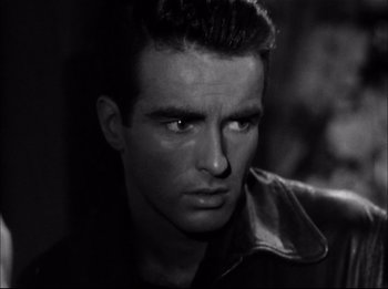 Movie still from “A Place in the Sun” (1951), directed by George Stevens – Black and white photograph of a man looking at the camera; Close Up shot, Low angle